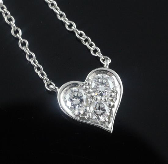 A modern Tiffany & Co platinum and three stone diamond set heart pendant necklace, pendant 7mm.